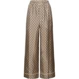 Gucci Bruna Byxor & Shorts Gucci GG Supreme wide-leg silk pants brown