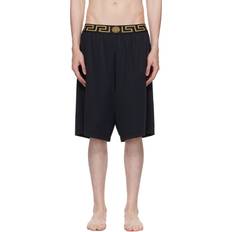 Versace Herr Badkläder Versace Long surf shorts with Greca trim a80g_black_gold_greek_key